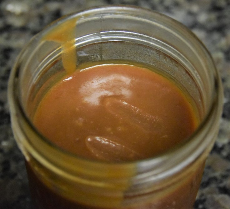 Close up photo of caramel sauce in a jar