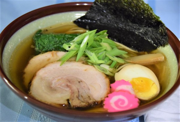 bowl of shoyu soy ramen with chashu, menma, narutomaki, egg, nori, spinach, and scallions
