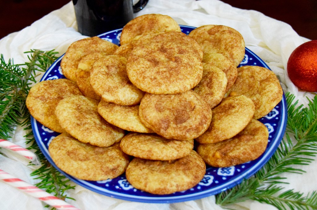 Pile of tan and brown cookies on a blue and white plate